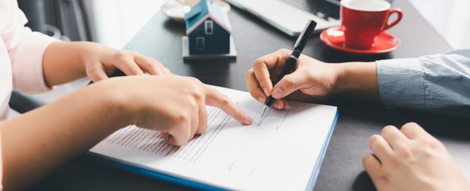 Mortgage in principal vs Mortgage offer - person signing document on desk