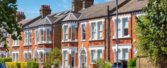 Row of traditional brick terraced houses in London, England, with classic architecture and street view