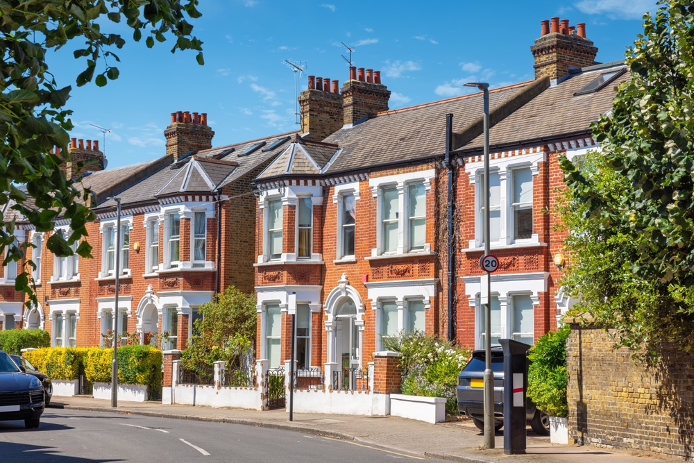 Row of traditional brick terraced houses in London, England, with classic architecture and street view